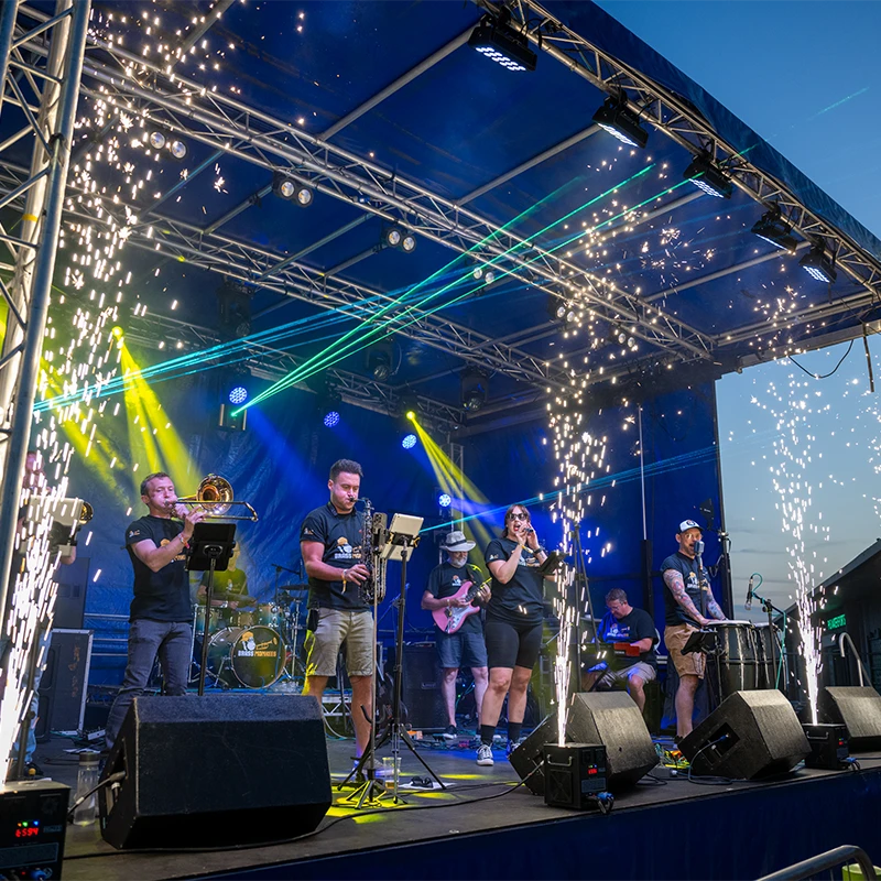 Brass Monkees on stage performing at an outdoor festival