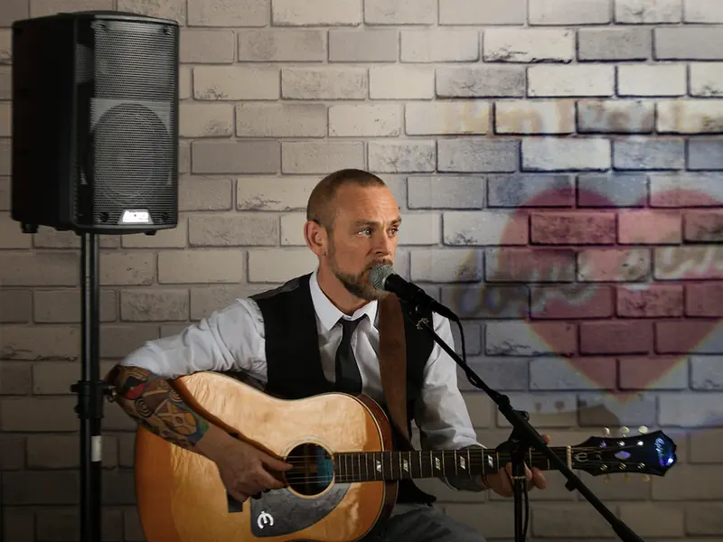 Acoustic guitarist and singer performing classic and modern hits