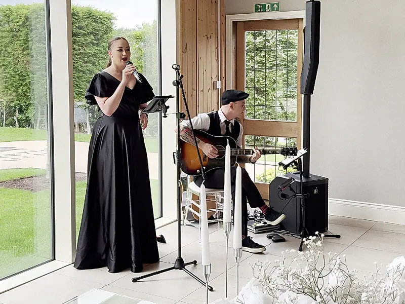 Brass Monkees singer and guitarist performing at a wedding ceremony
