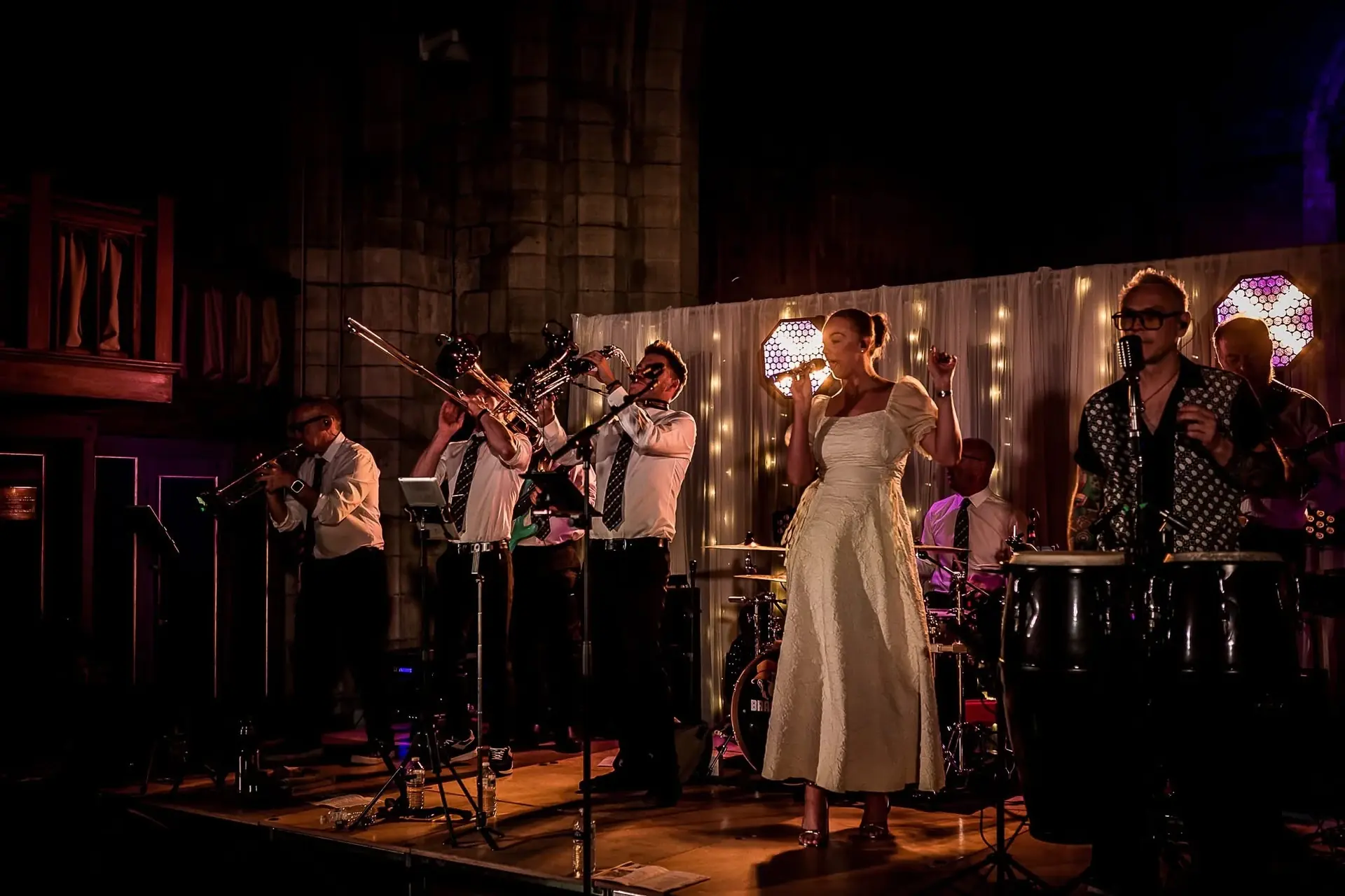 Brass Monkees 9-piece band performing live on stage with singers and a full horn section