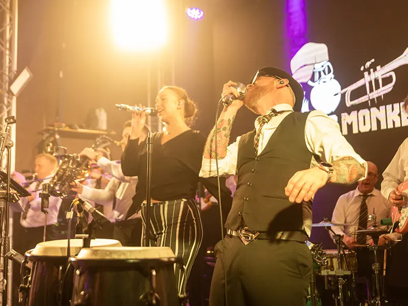 Brass Monkees two lead singers performing with the full band