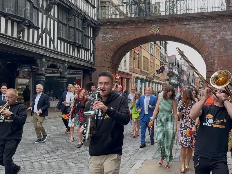 Brass Monkees roaming brass leading guests through the street, an add-on for Shropshire functions