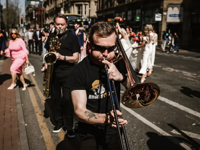 Brass Monkees roaming brass band trombone and sax leading a wedding party