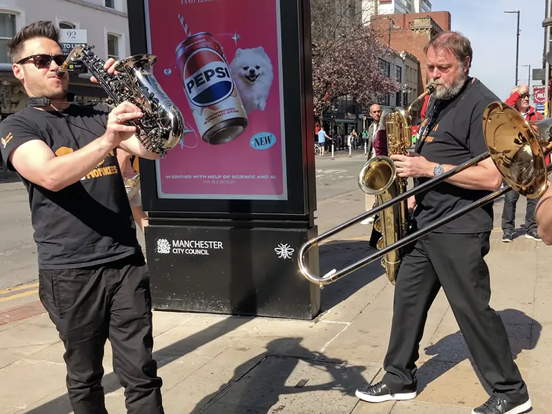 Brass Monkees roaming band saxophone and trombone players on the street